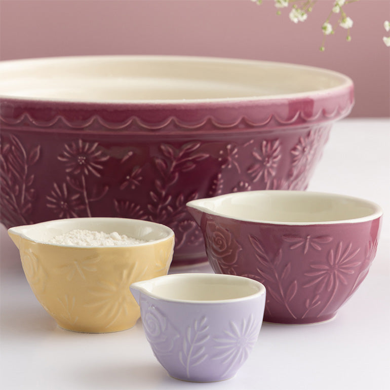Set of embossed ceramic bowls in various sizes on a light background