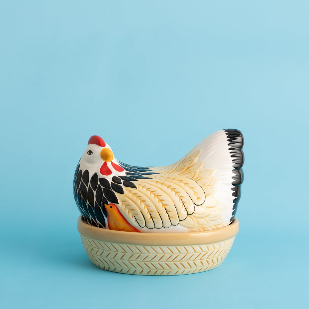 Decorative chicken-shaped container on a blue background