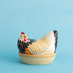 Decorative chicken-shaped container on a blue background