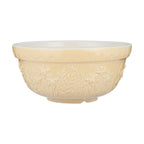 Cream-colored ceramic bowl with floral patterns on a white background
