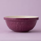 Purple ceramic bowl with floral patterns on a light purple background