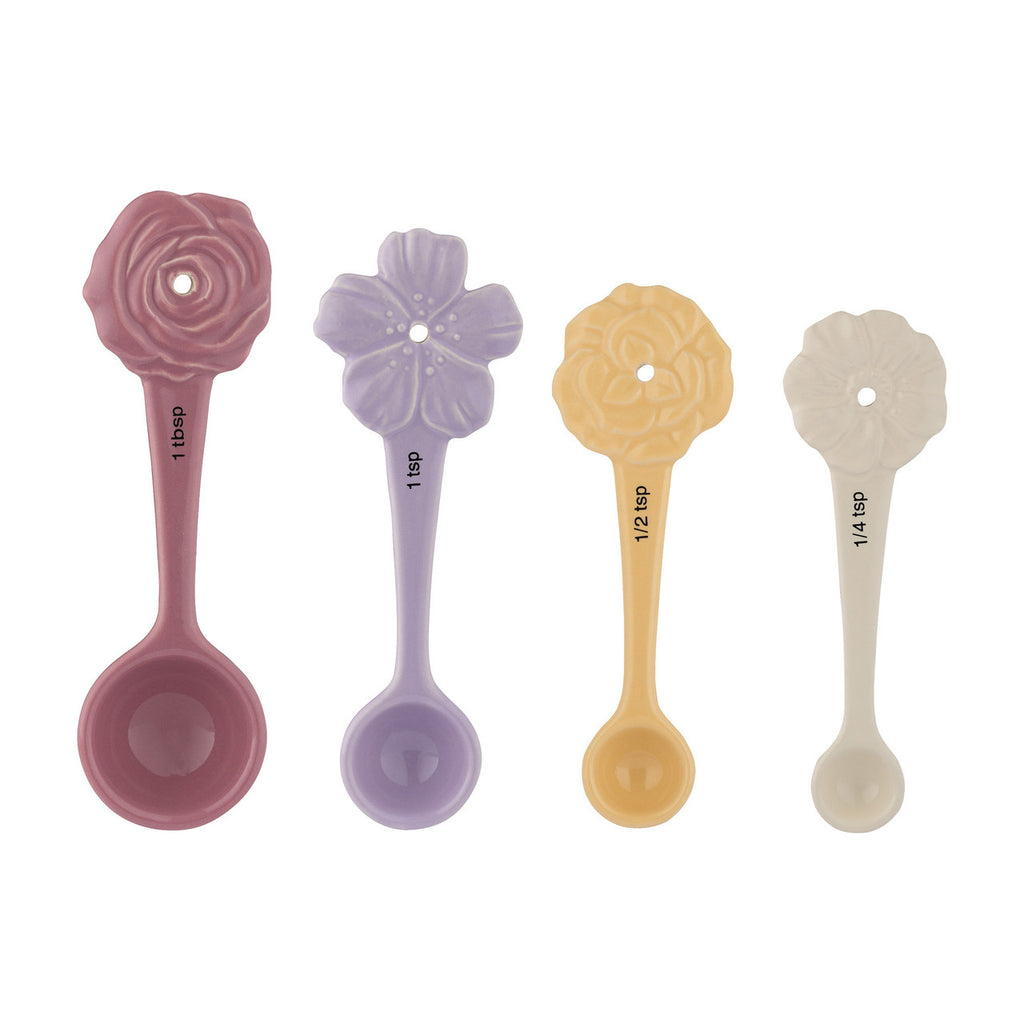 Set of four floral-themed measuring spoons in pink, purple, yellow, and beige on a white background.
