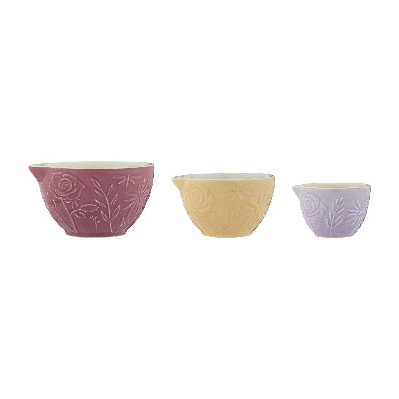 Three ceramic bowls in pink, yellow, and purple with floral patterns on a white background.