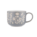 Gray mug with white floral patterns on a white background
