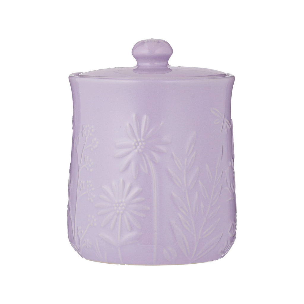 Lavender ceramic jar with textured surface and matching lid on a white background