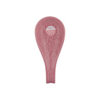 Pink ceramic spoon rest with floral patterns on a white background