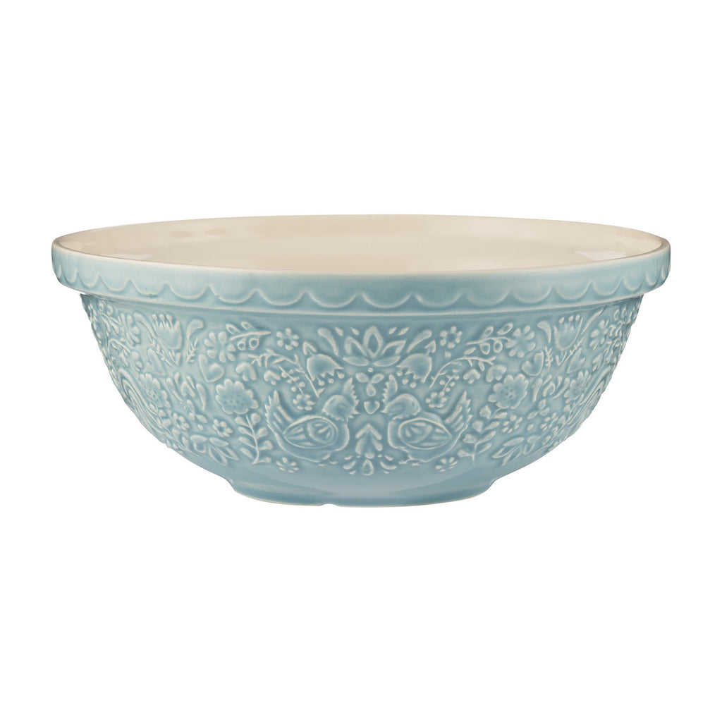 Decorative light blue ceramic bowl with intricate patterns on a white background