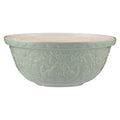 Decorative light green bowl with floral patterns on a white background