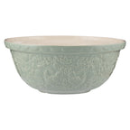 Decorative light green bowl with floral patterns on a white background
