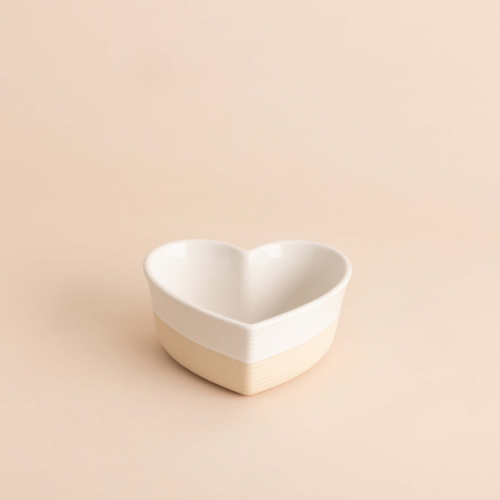 Heart-shaped ceramic bowl on a beige background