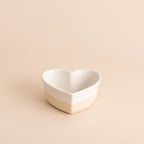 Heart-shaped ceramic bowl on a beige background